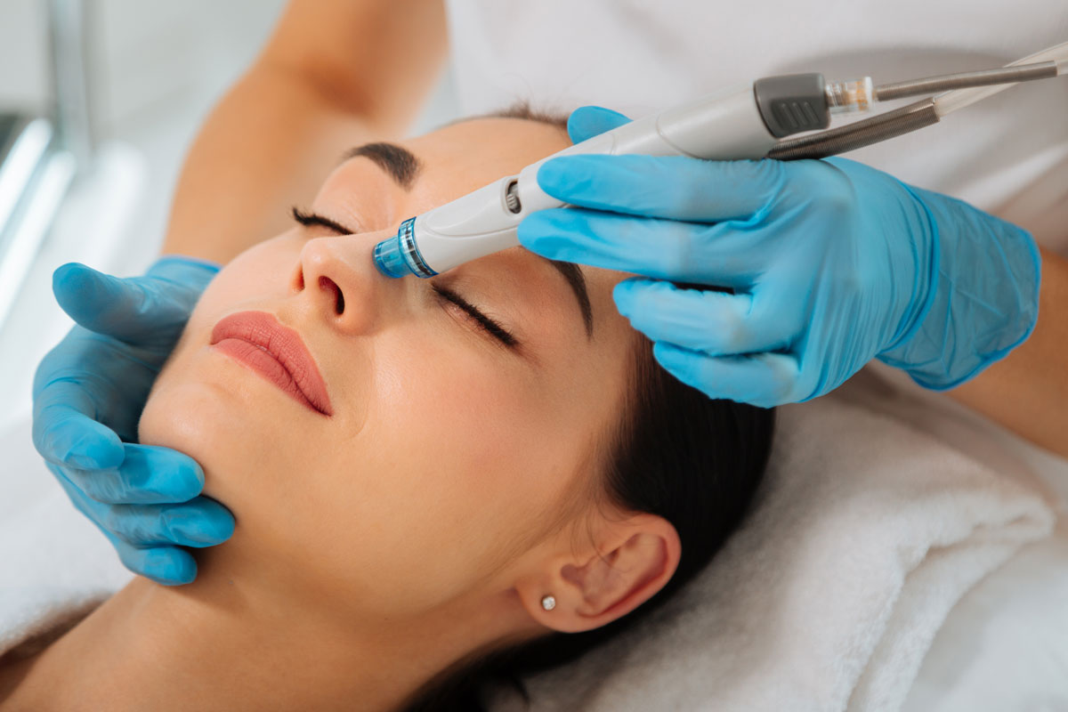 delighted-nice-woman-lying-medical-bed-with-her-eyes-closed-while-having-hydrafacial